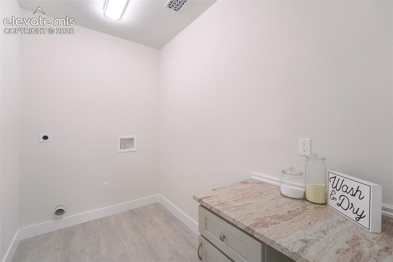 Convenient Upper Level Laundry Room with folding station.