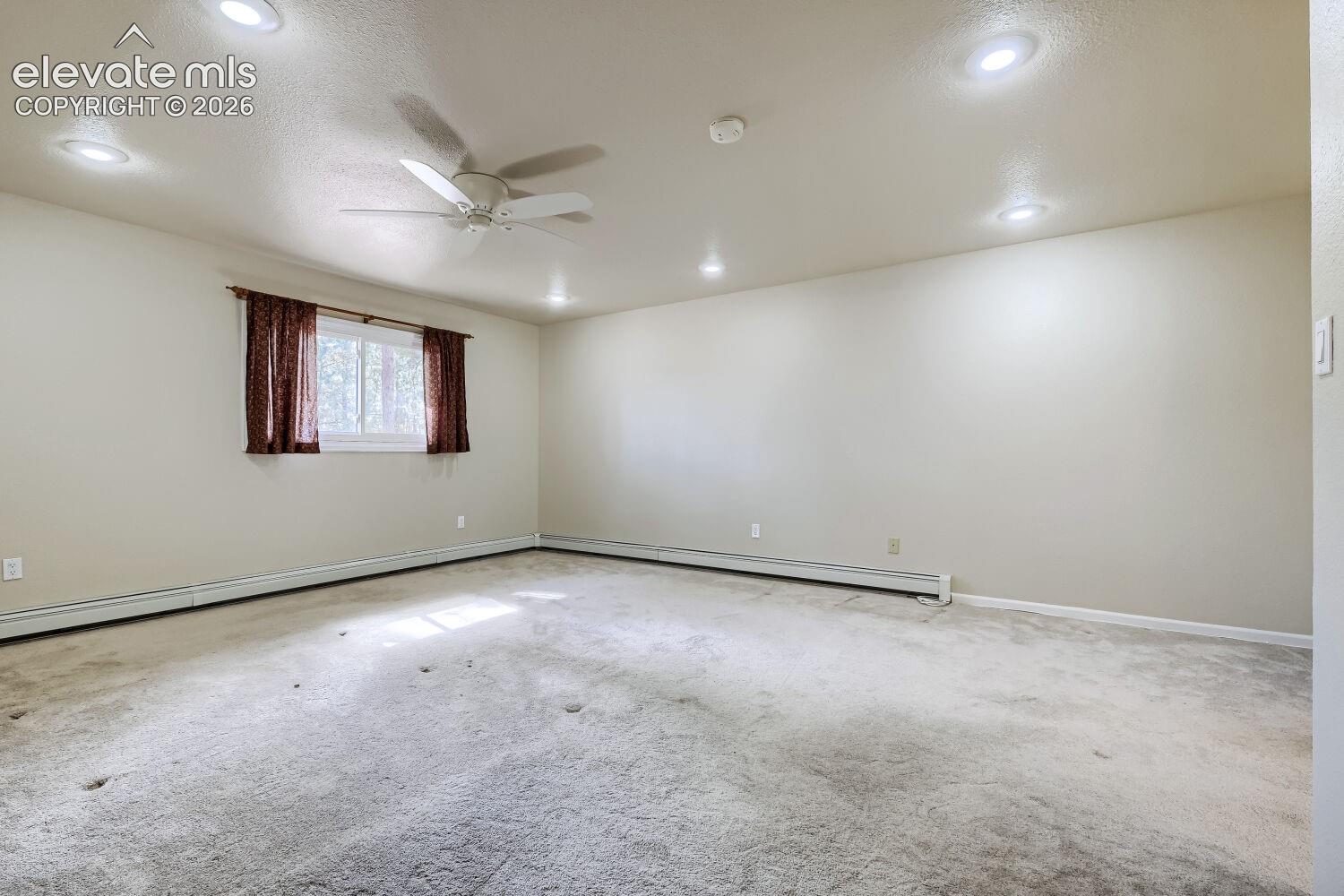 Recessed lighting, ceiling fan, single window, and carpeted flooring
