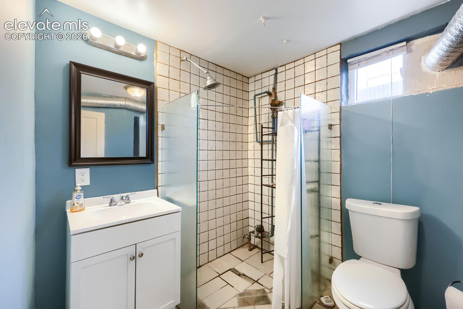 Vanity with integrated sink, framed mirror, and chrome fixtures