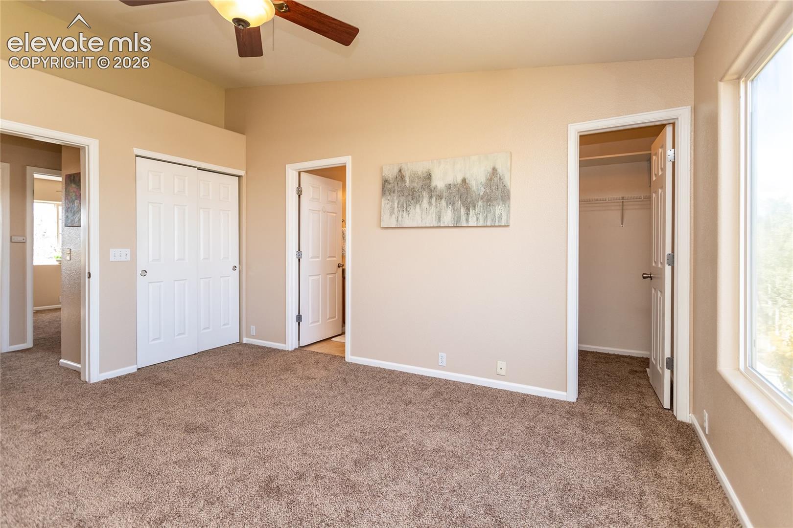 This primary suite includes both a double sliding door closet and a dedicated walk-in closet for maximum storage