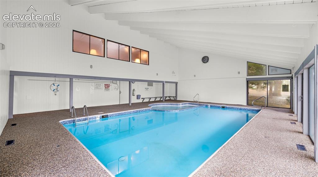 Indoor swimming pool with an exposed beam vaulted ceiling