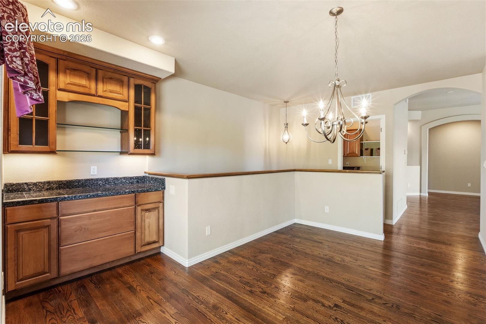 DINING ROOM WITH BUILT-IN CABINETS AND GLASS SHELVES