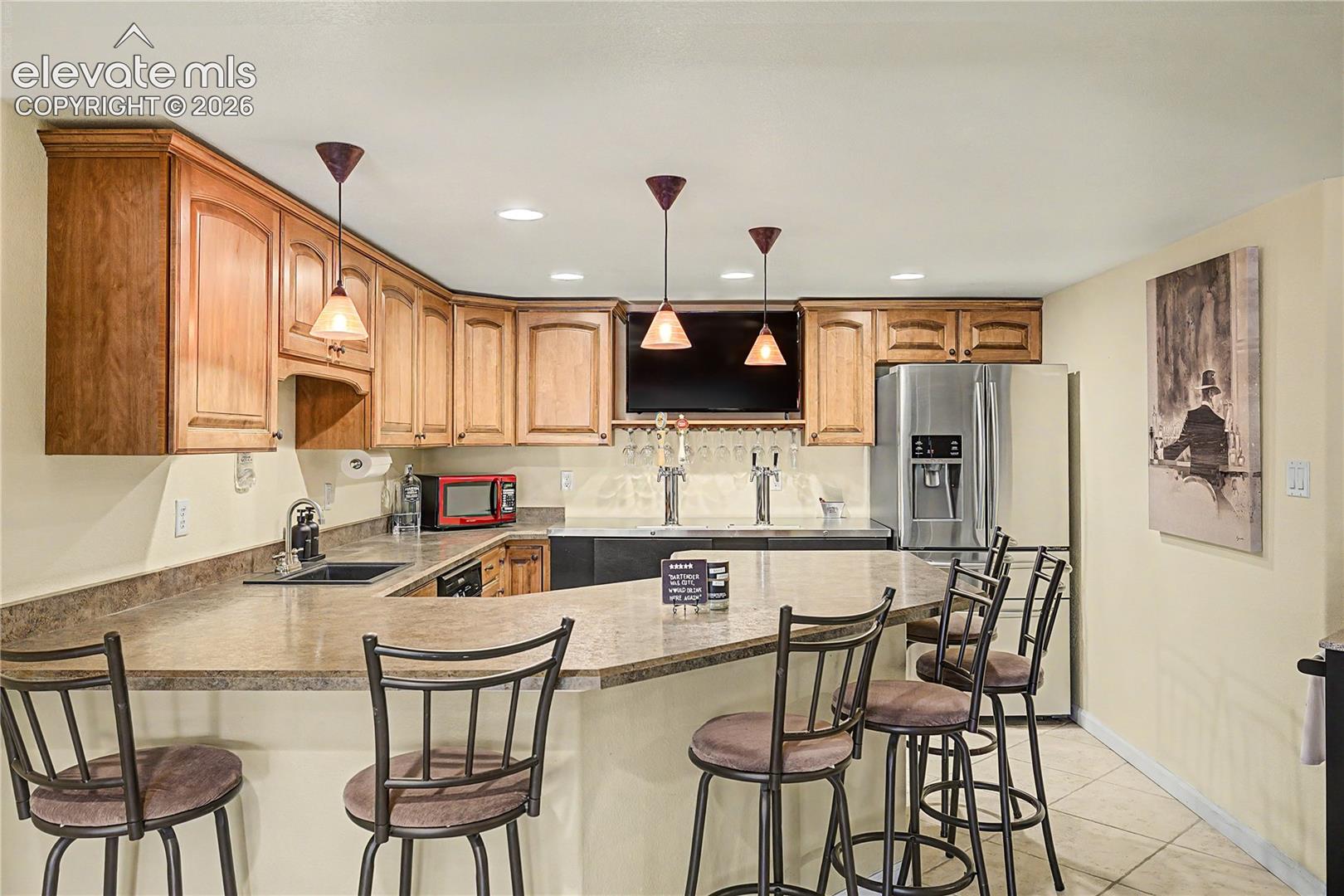 The wet bar's stainless appliances and spacious counters keep the space functional as well as stylish.