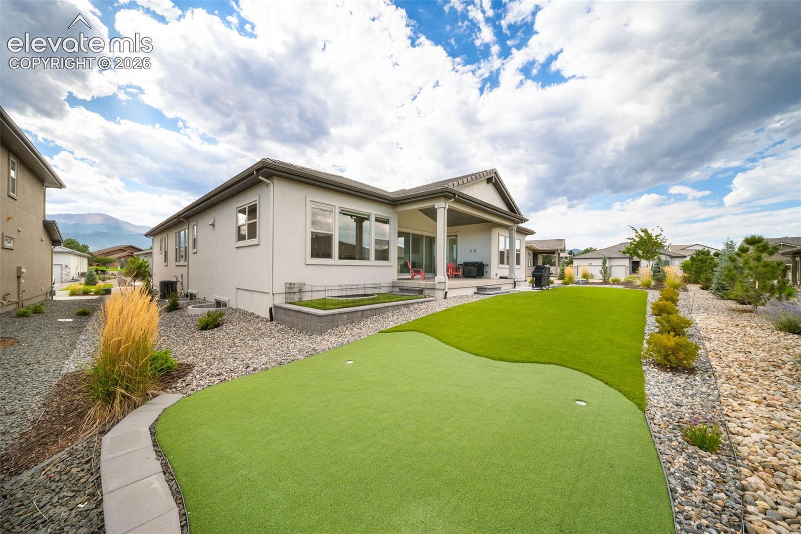 Turf with putting green and small dog run.