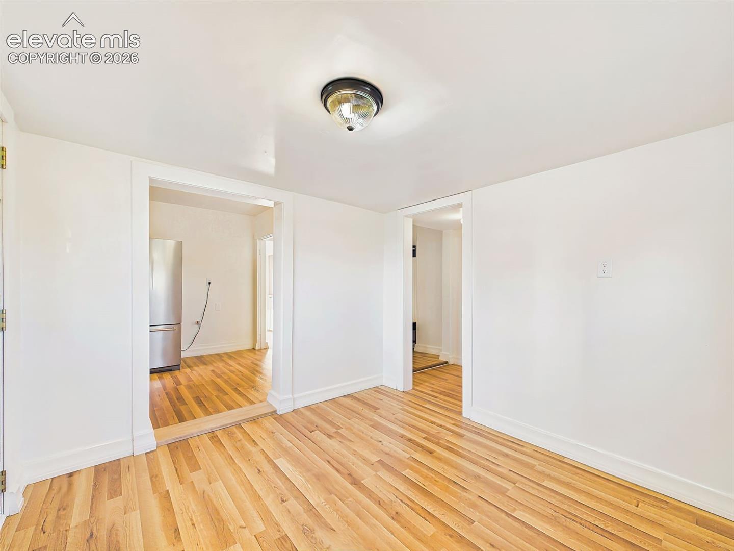 Dining Room – Spacious dining area provides flexibility for formal meals, casual gatherings, or a home office setup, with updated flooring and abundant natural light.