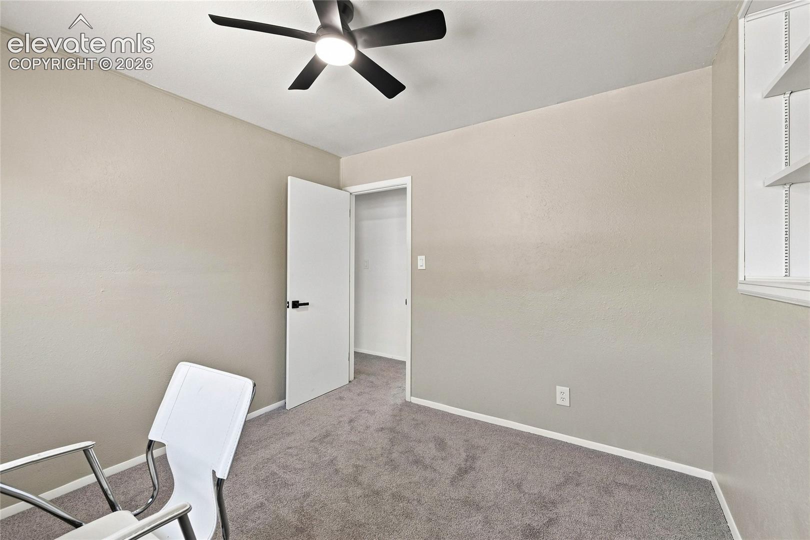 Neutral-toned walls complement the gray carpeting