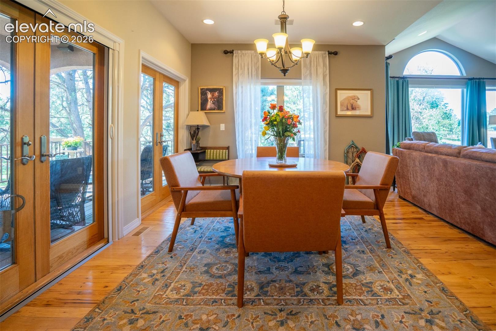 The Dining area is off the living rm and opens to 2 Pella Brand French doors leading to the covered deck