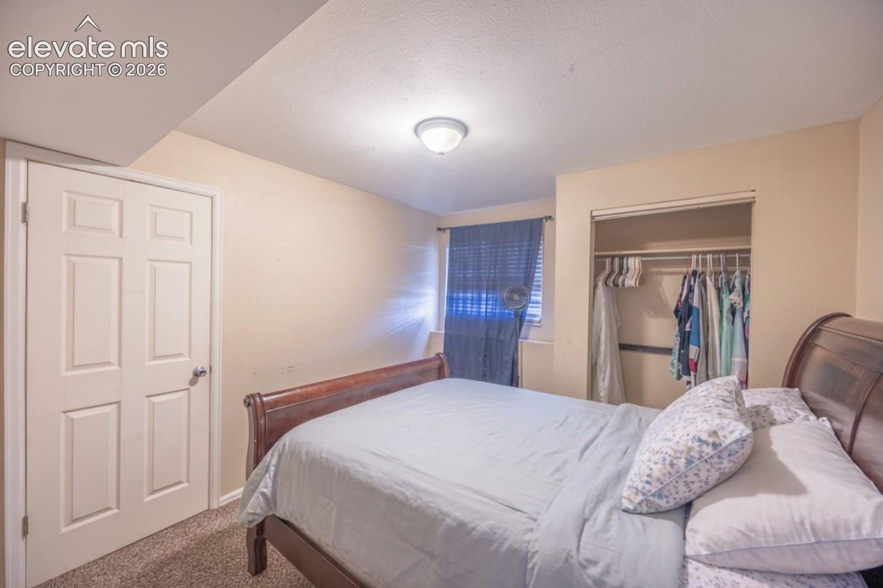 Recessed lighting, carpet flooring, paneled interior door, and built-in closet with hanging rods