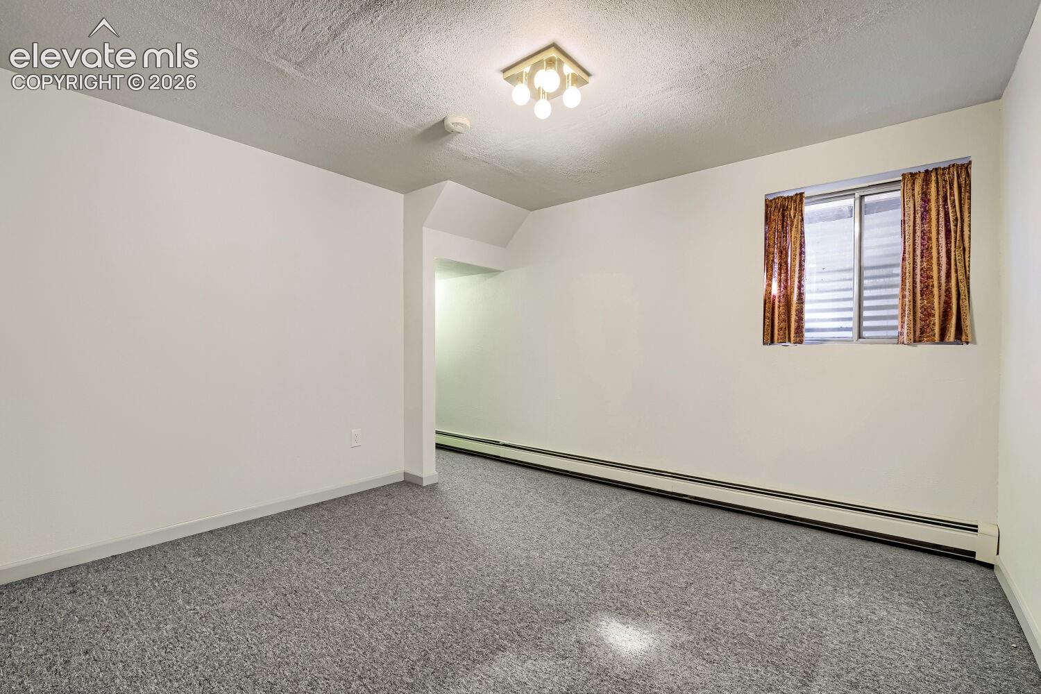 Recessed window, ceiling-mounted light fixture, and baseboard heating