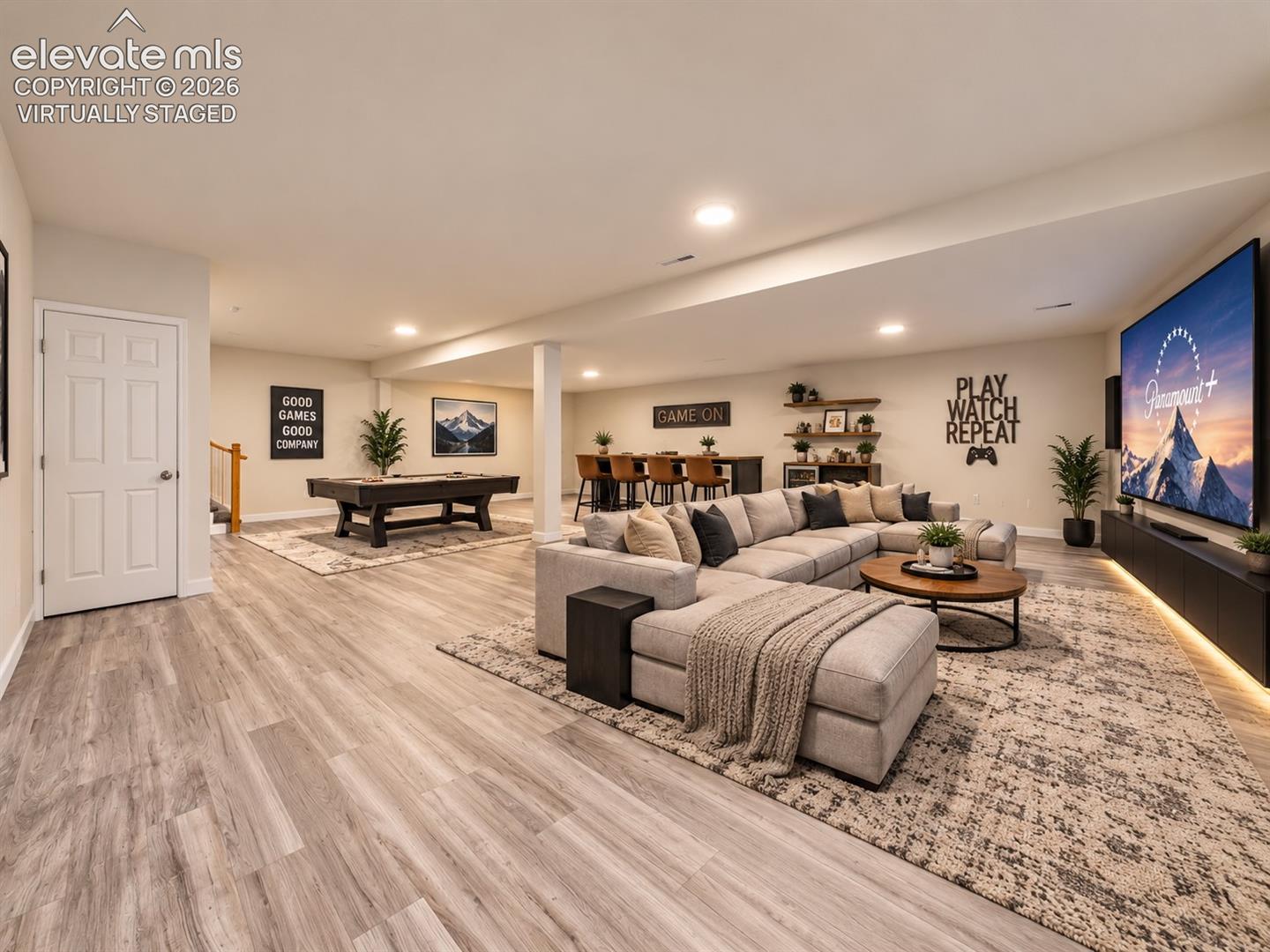 Virtually Staged Basement – Virtually staged to demonstrate the expansive finished basement’s potential as a media and recreation space, with room for comfortable seating, gaming, and a pool table. Virtually staged.