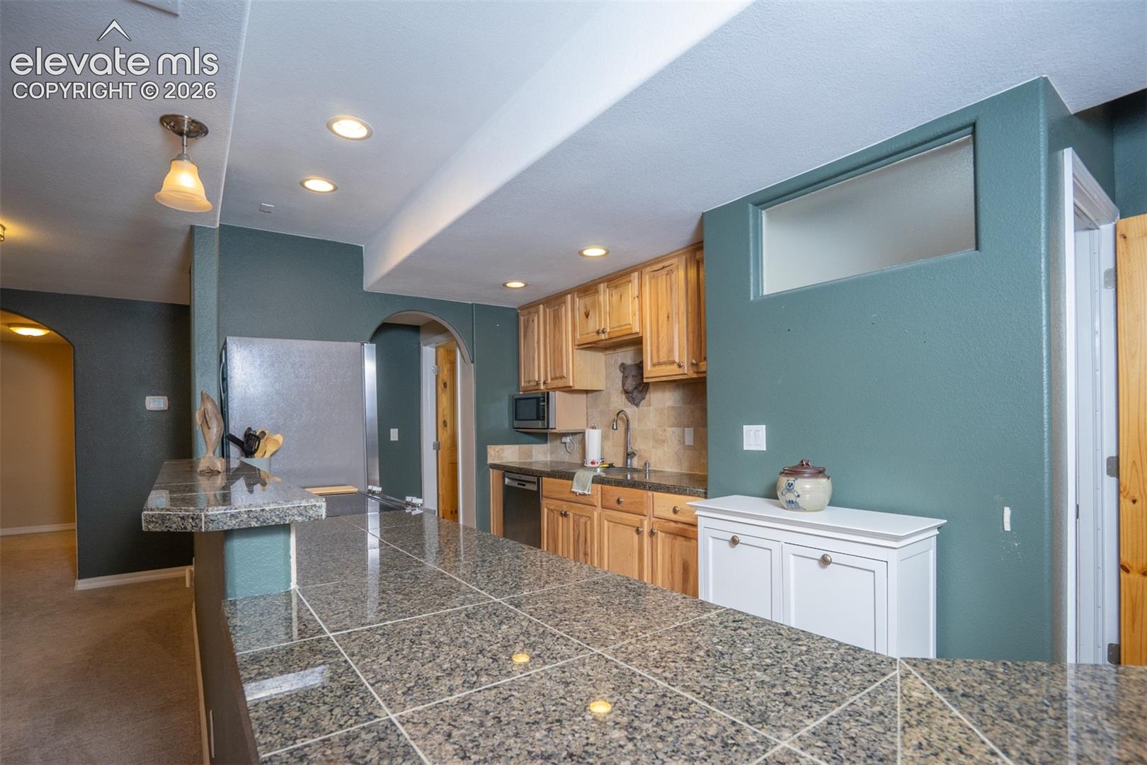 A full kitchen in the basement including a full elect range/oven, refrig, dw, and microwave. It's all you need for this home within a home.