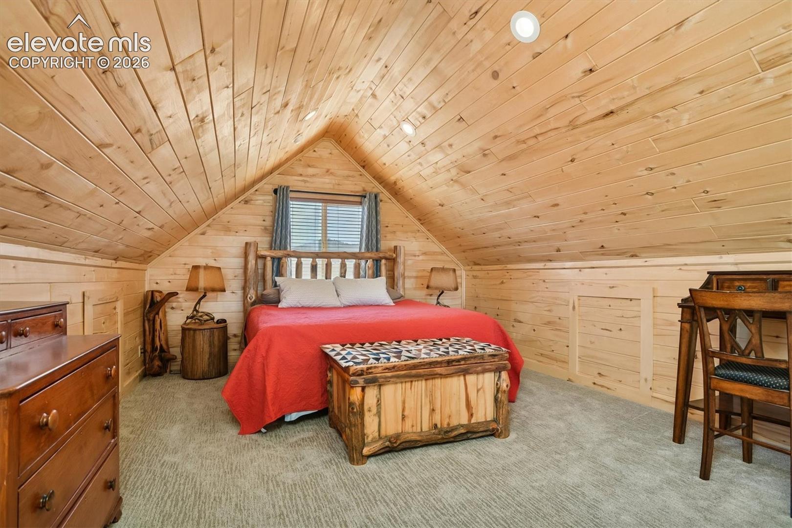Vaulted wood-paneled ceiling with recessed lighting