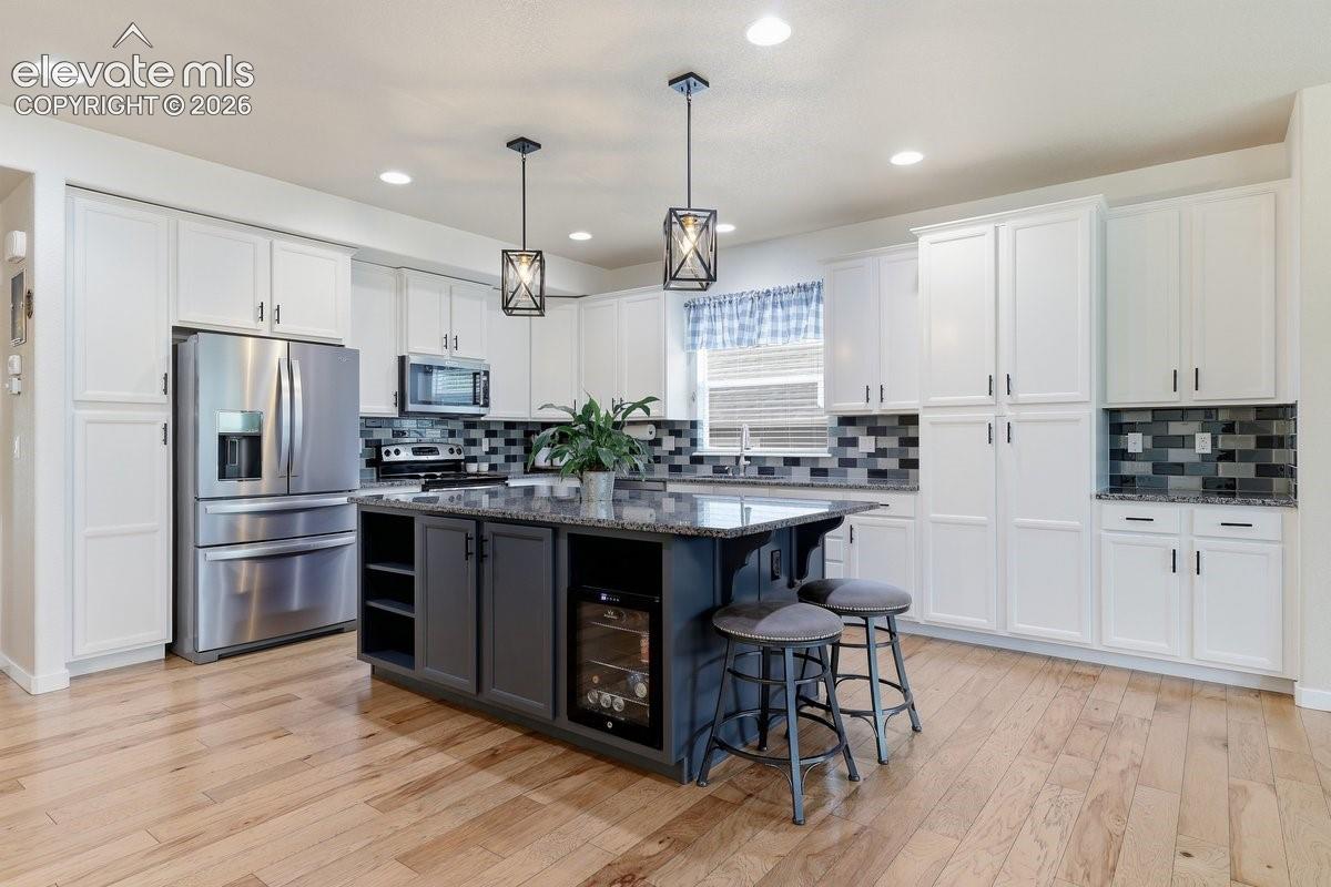 granite countertops, stainless steel appliances, and lots of cabinet space plus a separate pantry