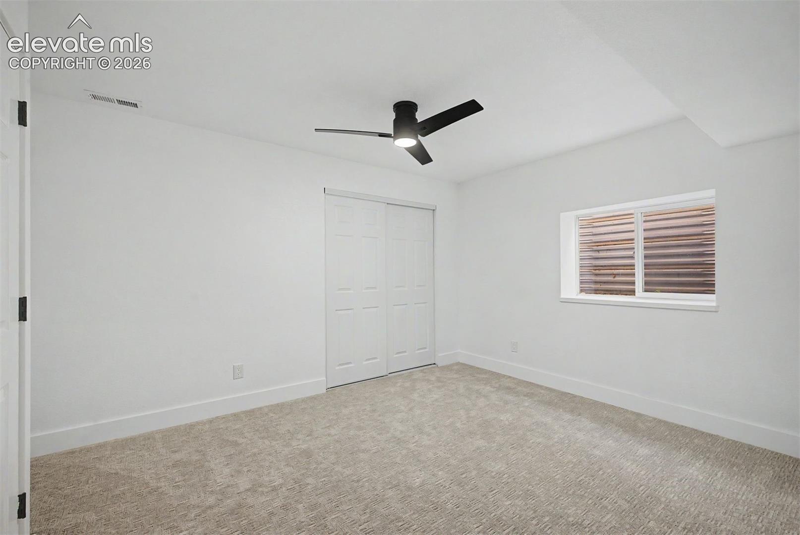 Basement bedroom with ceiling fan