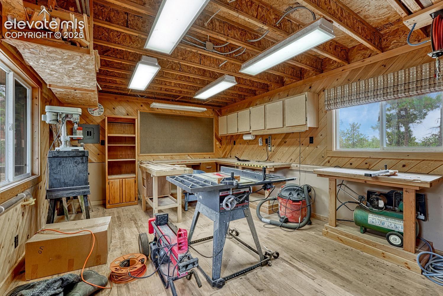 Interior of powered workshop with oak floors and built-in cabinetry.
