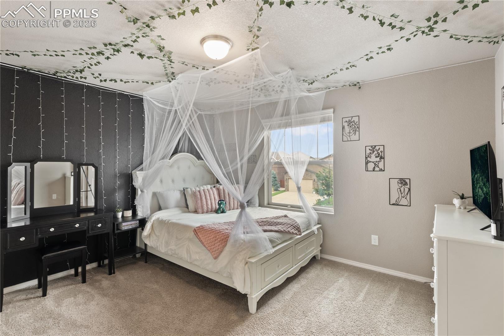 Bedroom with light carpet and baseboards