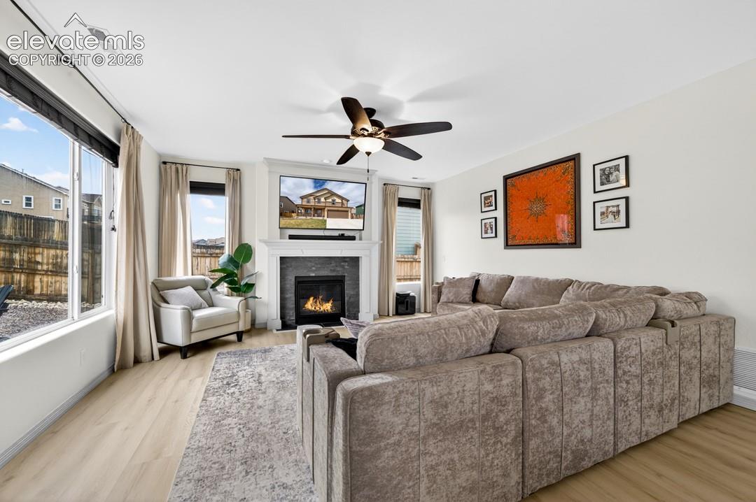 Gas fireplace, large windows, ceiling fan, luxury vinyl, surround sound speakers