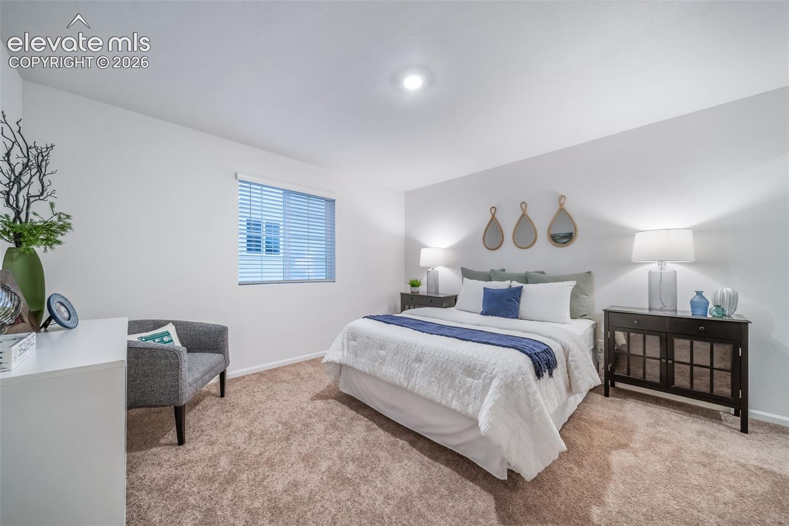Recessed ceiling lighting, white walls, window with blinds, carpeted flooring, and a dark wood-finish built-in cabinet
*photos of a model home*