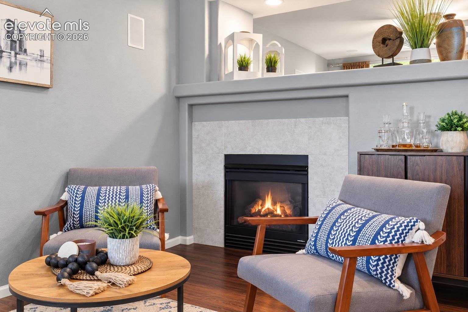 Gather around the fireplace in a comfortable living space that feels warm and connected.