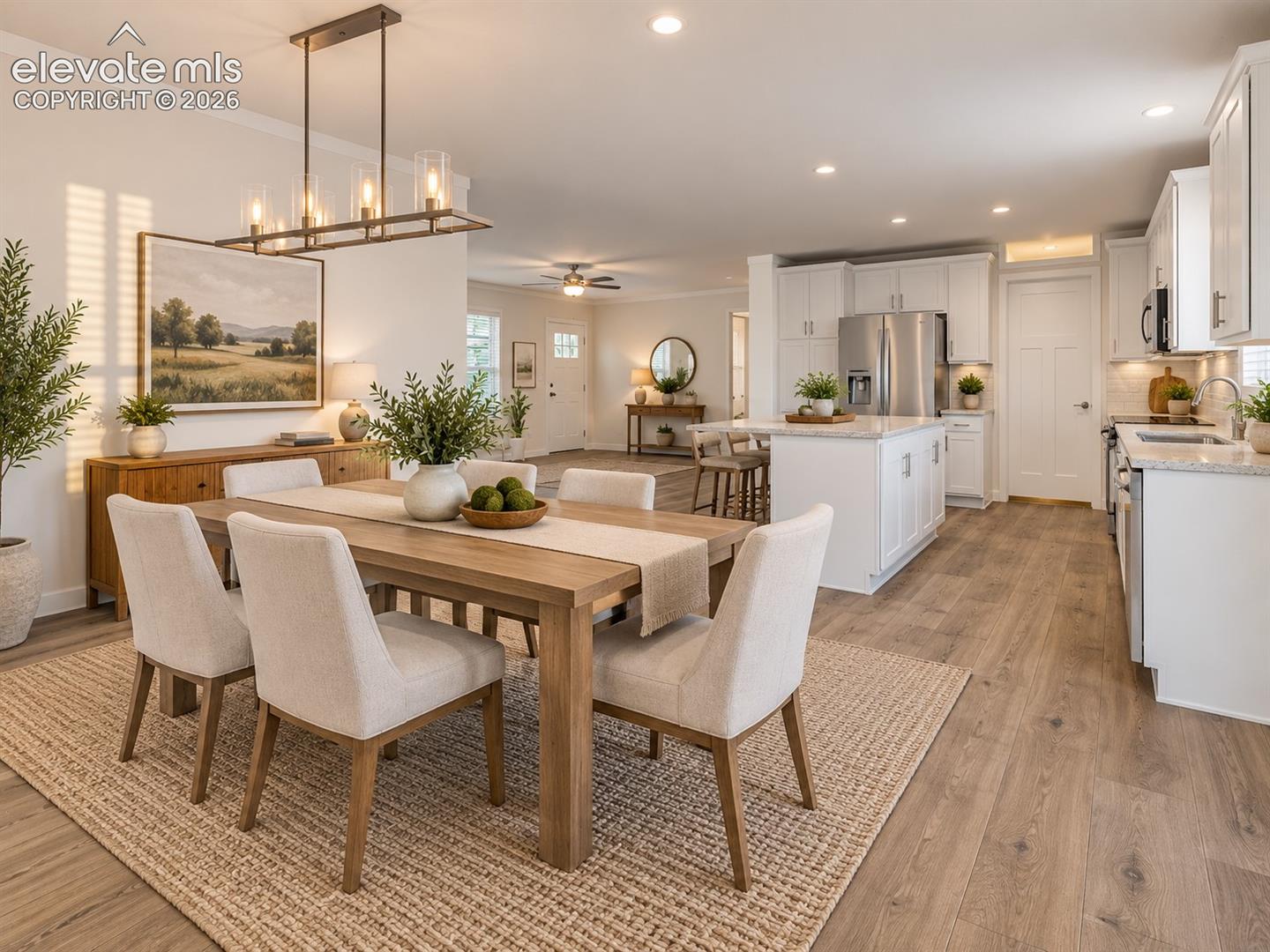 Spacious dining area connects seamlessly with the kitchen and adjoining living space, showcasing the home's open ranch-style layout and wide-plank flooring.