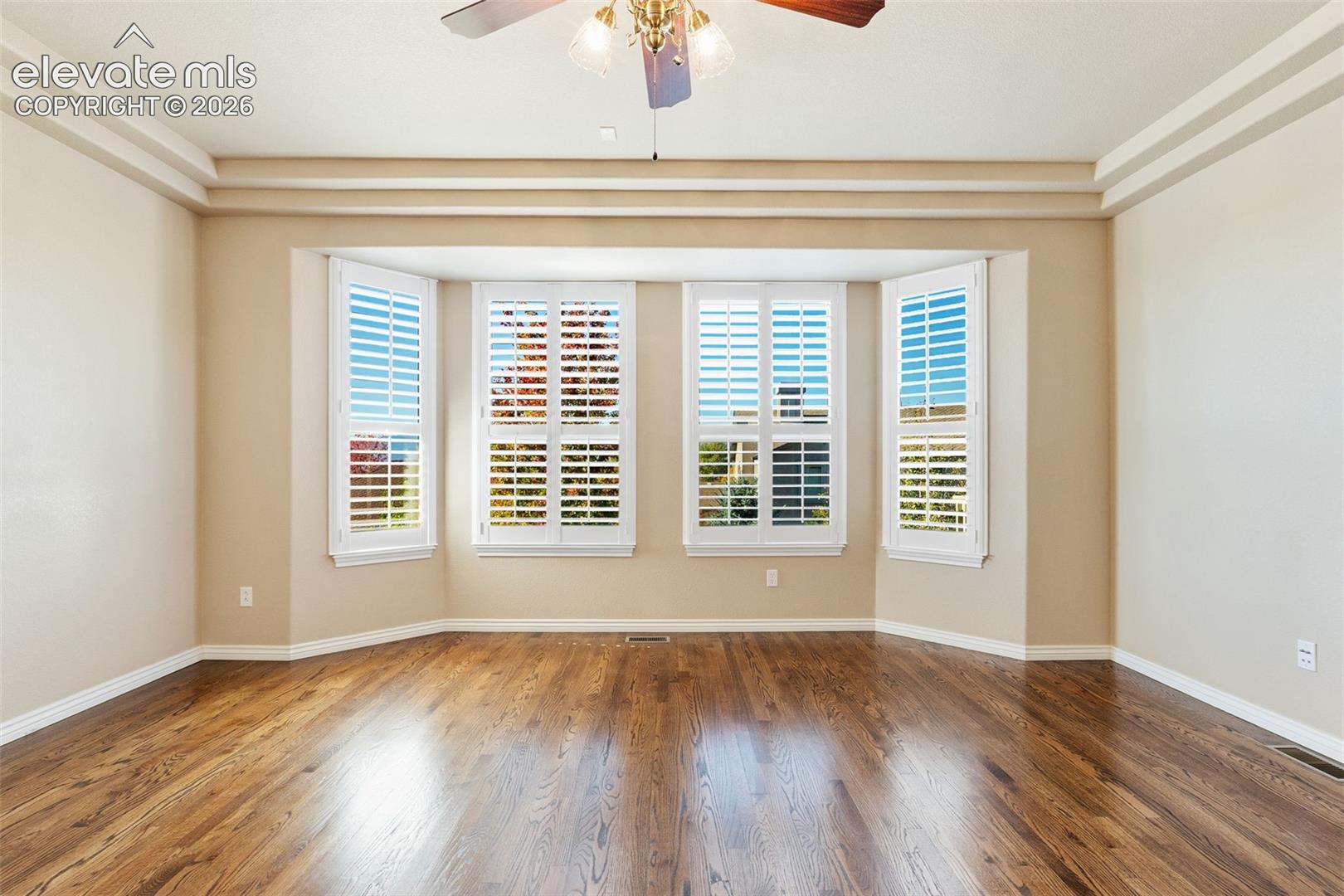 WALL OF WINDOWS IN PRIMARY BEDROOM