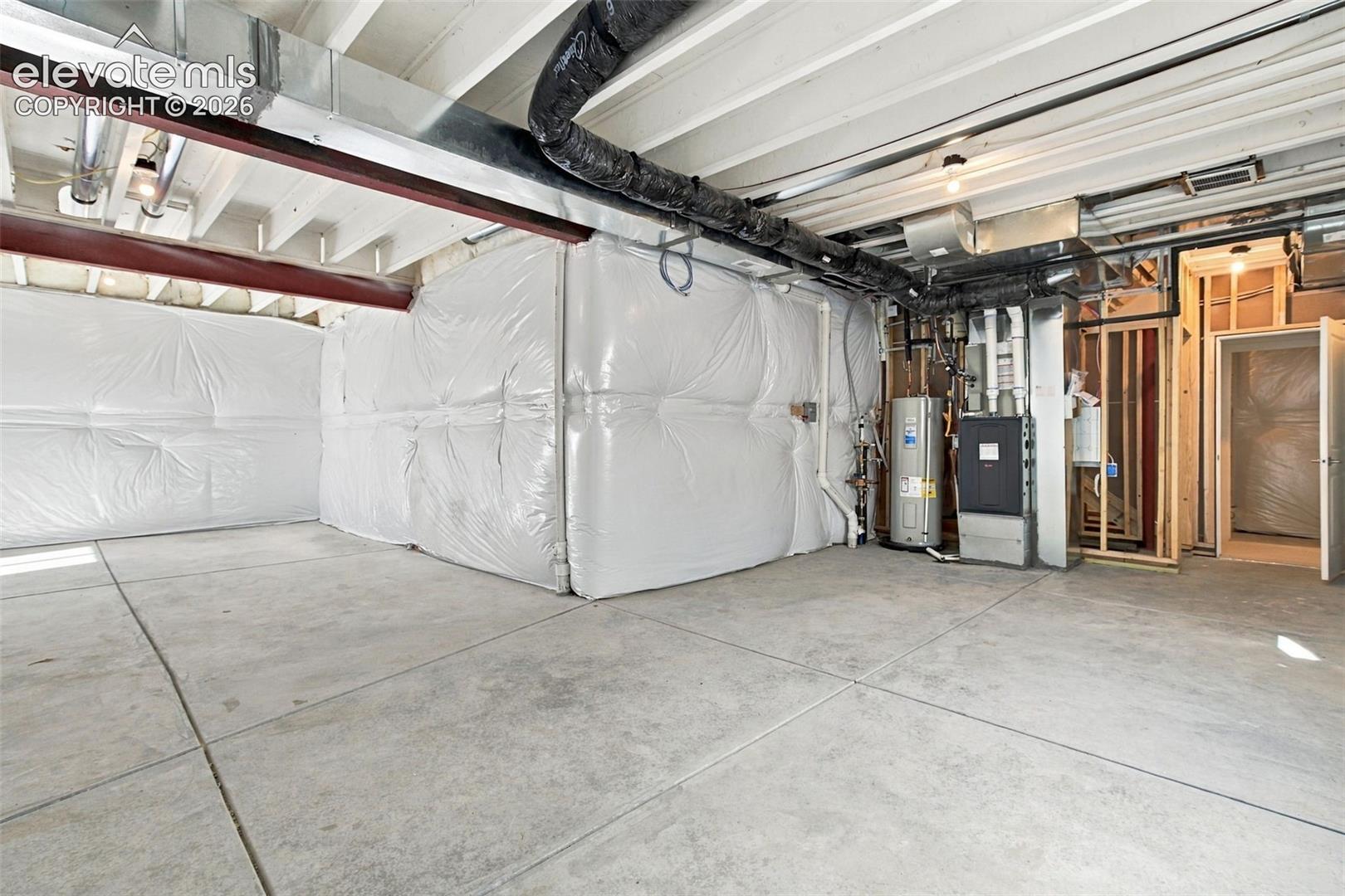 Expansive concrete flooring in an unfinished lower level