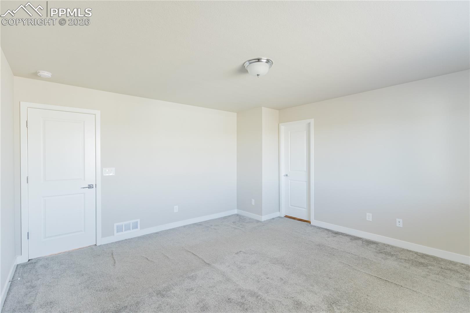 Spare room with light colored carpet