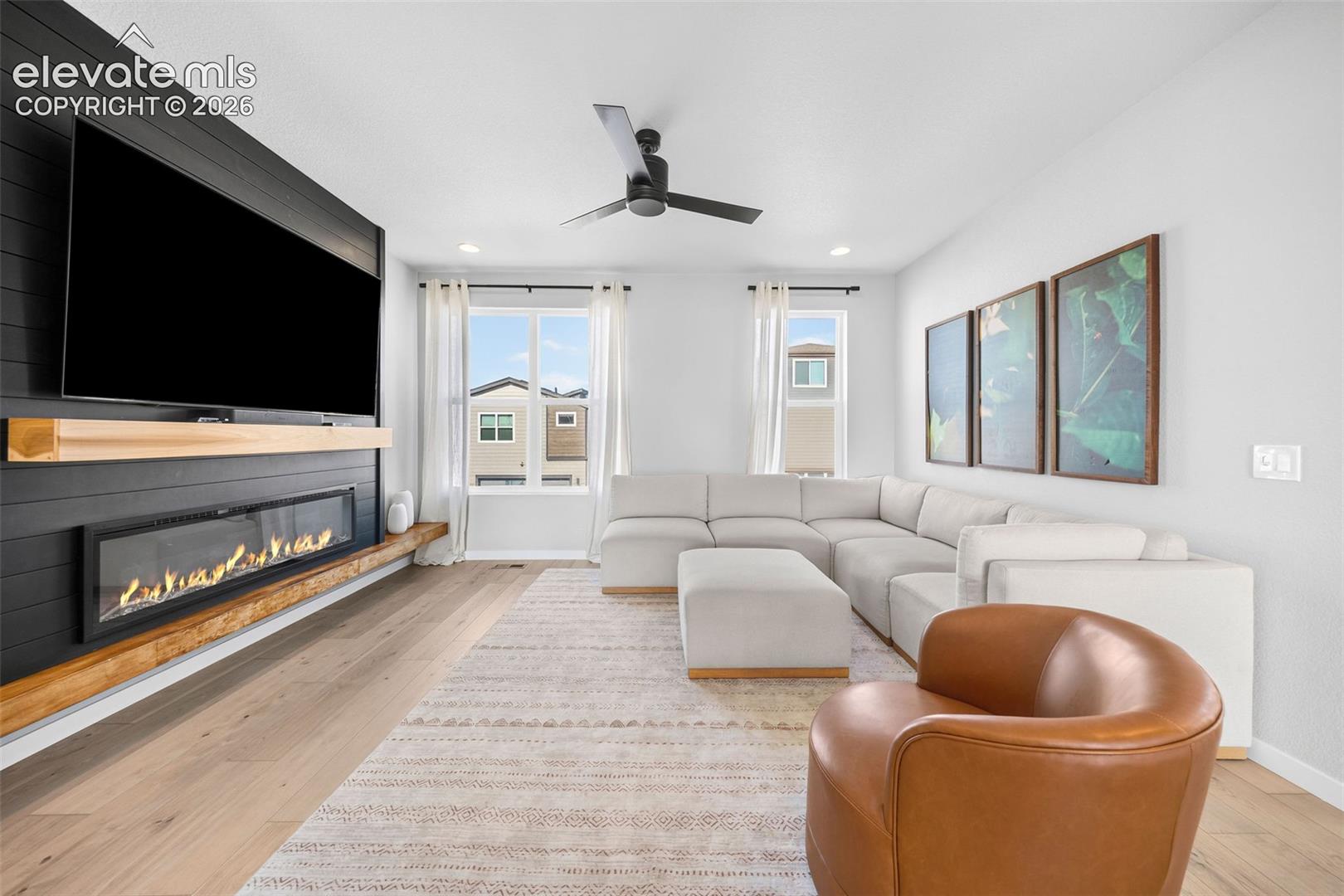The star of the living room is this gorgeous feature wall with a built-in fireplace, wood mantel and wooden ledge. 