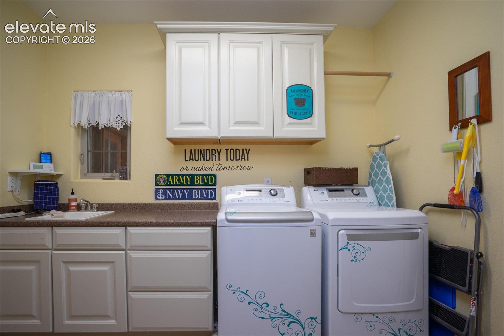 The laundry room is between the kitchen and garage. There's a separate powder bath, too, to wash up from the garage or for guests as needed.