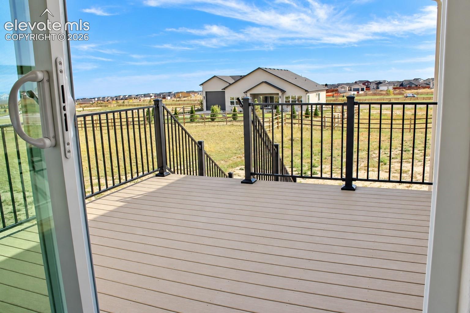 Deck with composite decking, black metal railings, and integrated steps