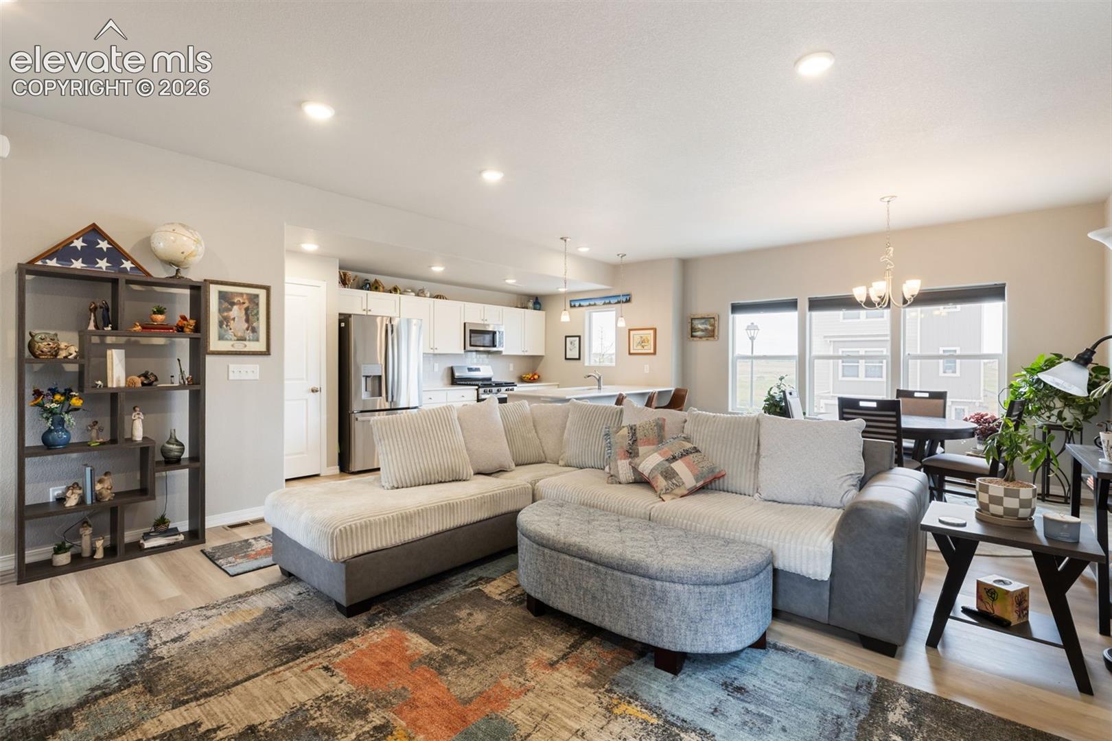 Open-concept living space featuring recessed lighting and wood-finish flooring