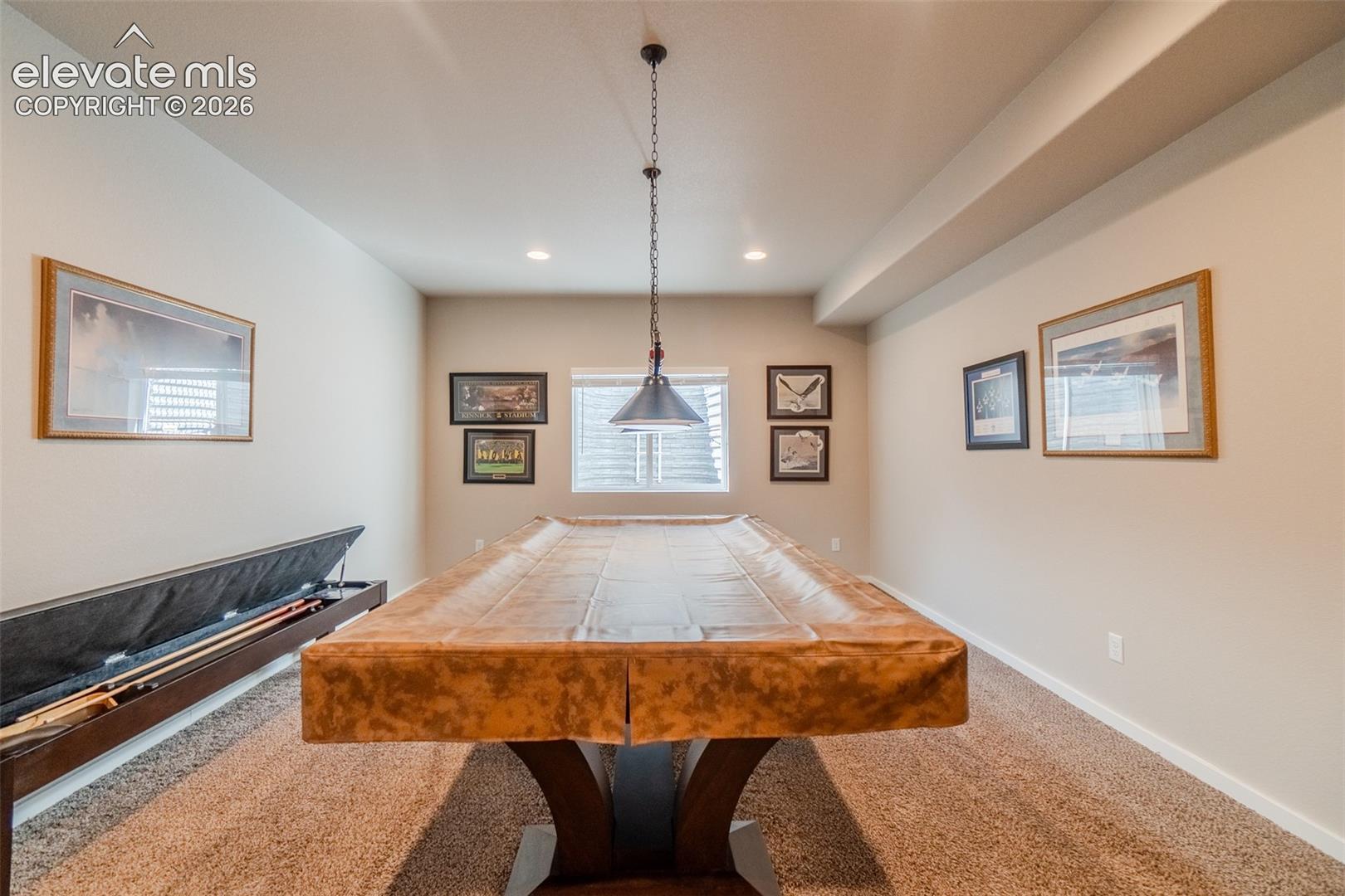 Entertainment room featuring wall-to-wall carpeting, recessed lighting, and a window with horizontal blinds