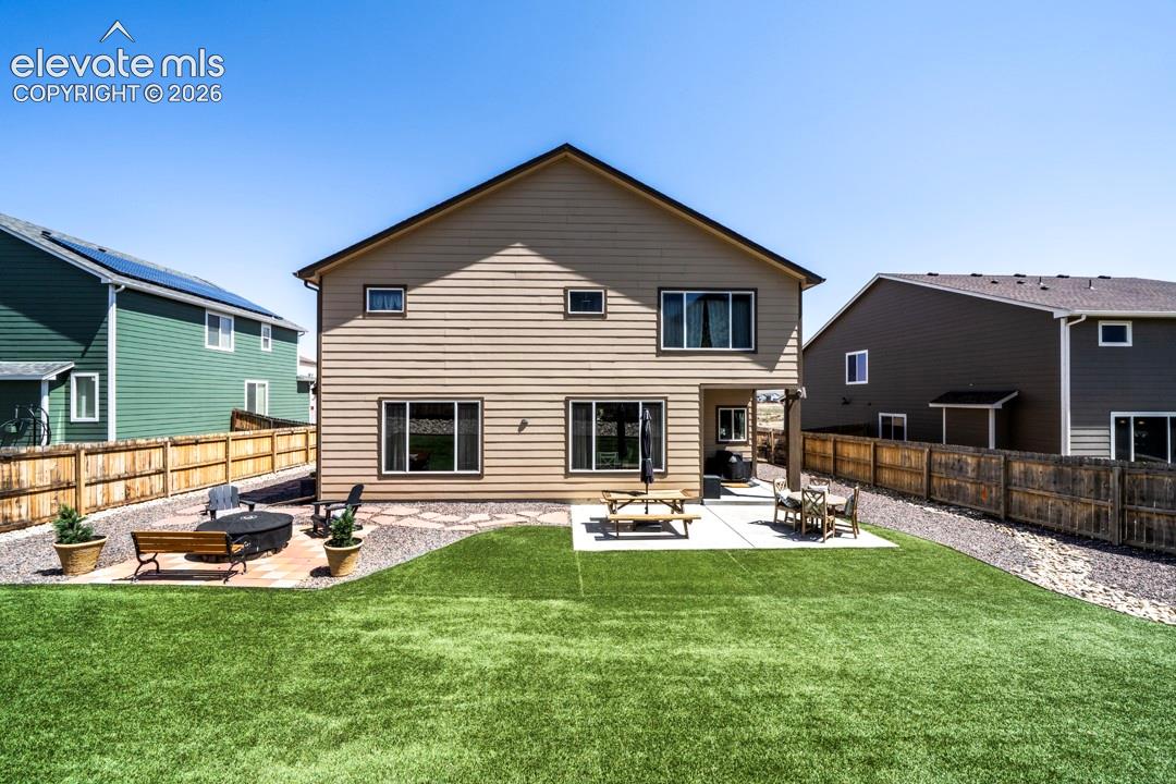Backyard, astroturf, covered patio, firepit, flagstone walkway, storage shed