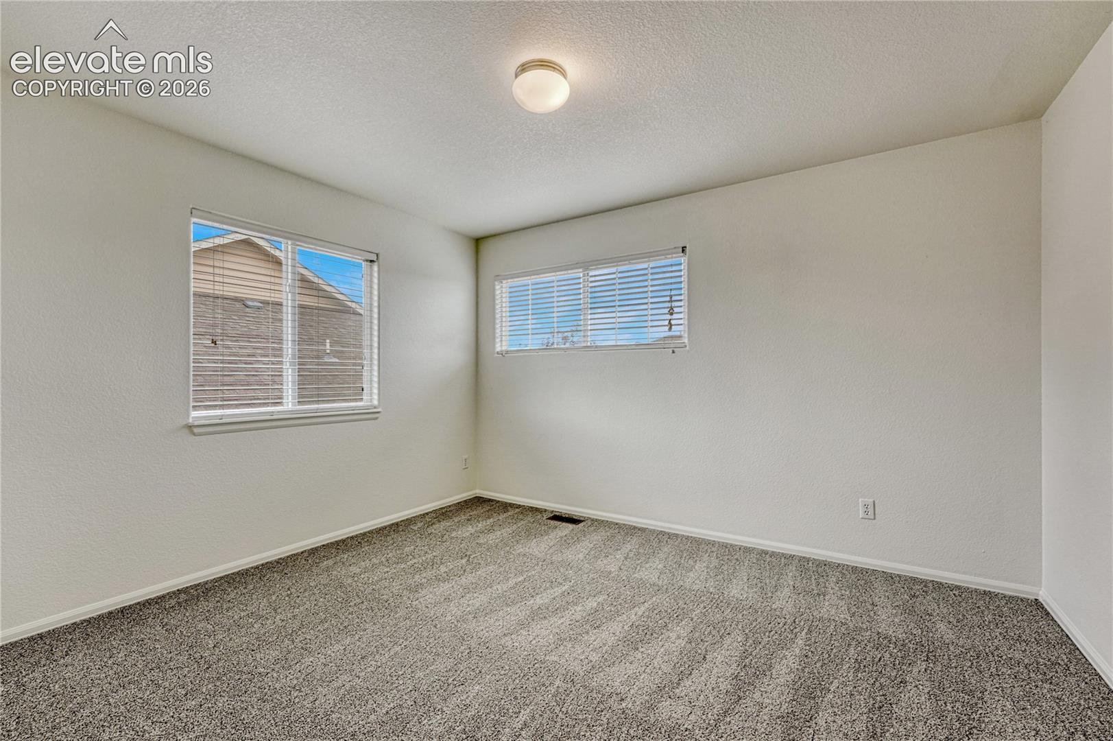 Second of two upstairs bedrooms. 