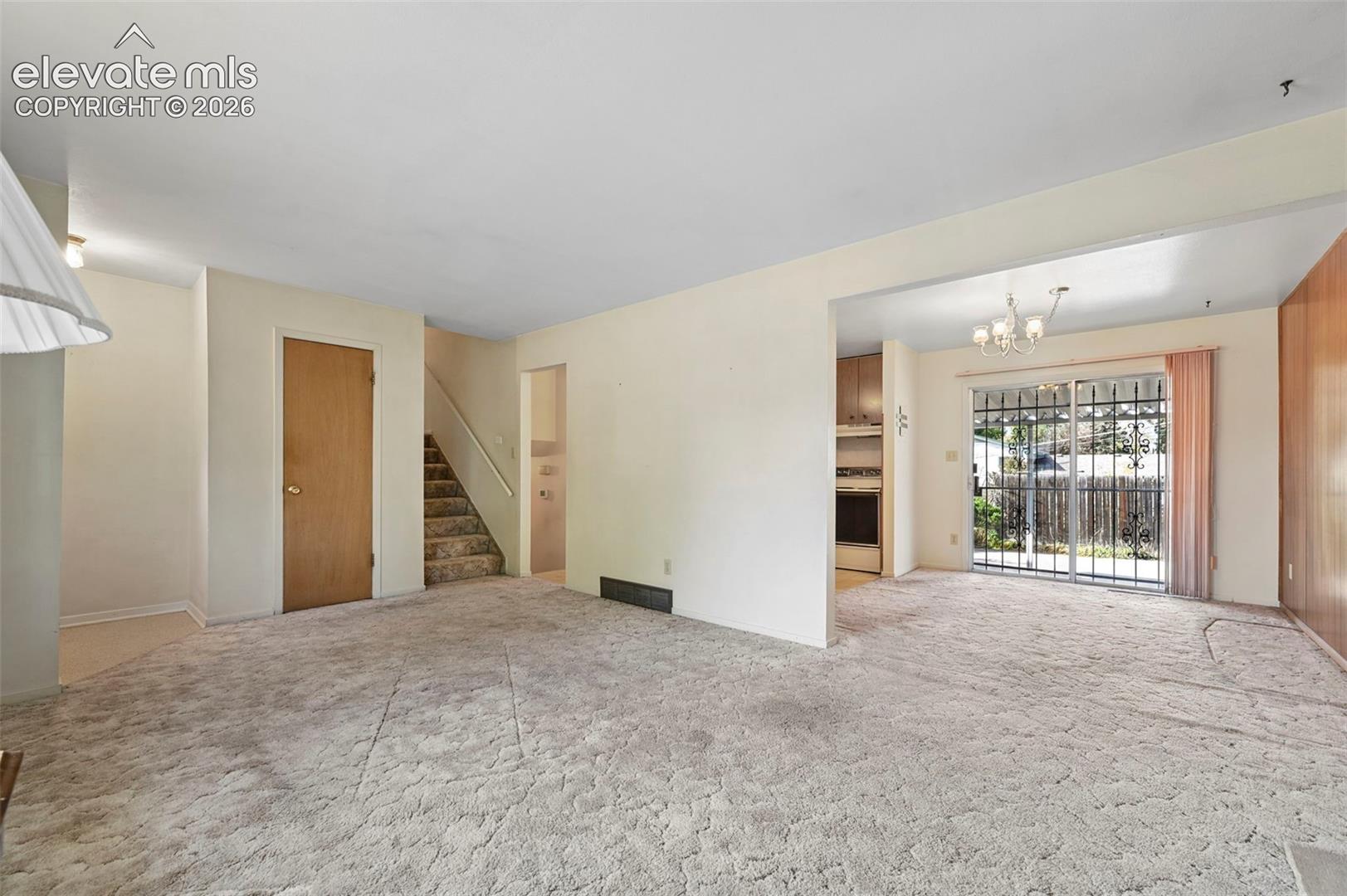 Living Room opens to Dining Room with walkout to covered patio