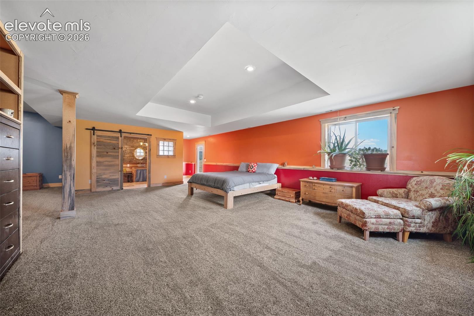 Expansive walkout primary bedroom with abundant space.