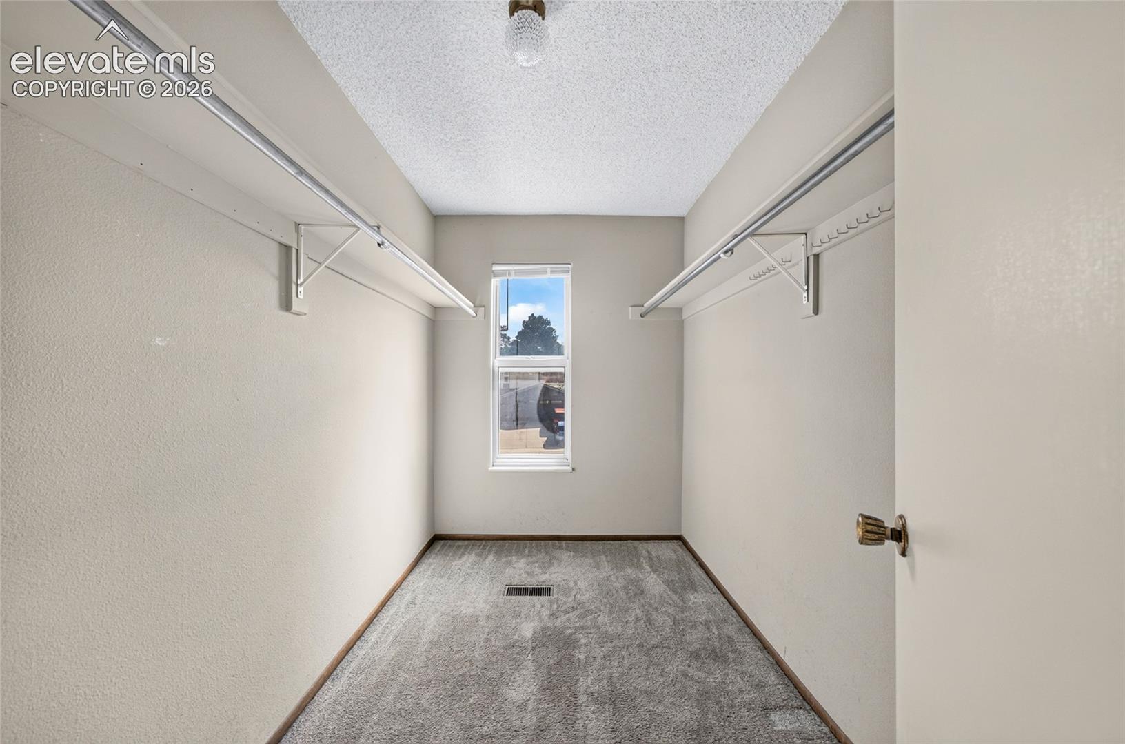 Primary bedroom walk-in closet