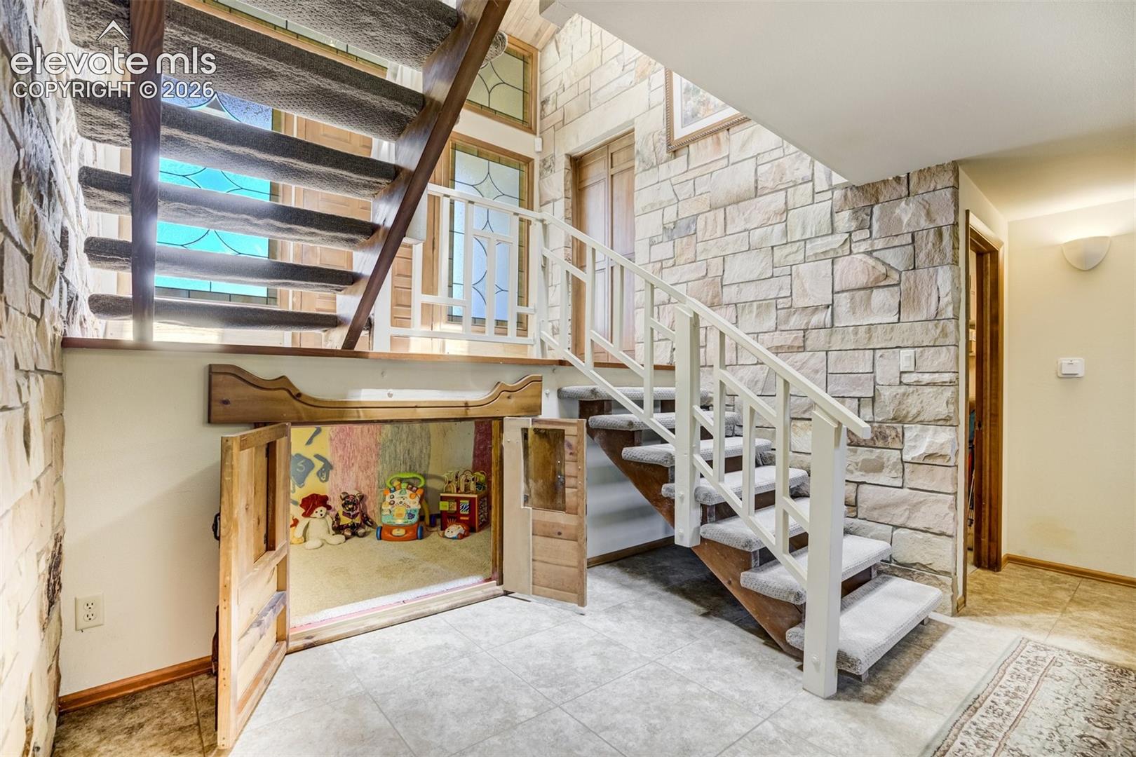 Cubby under the stairs can be used for a reading/play spot or storage.
