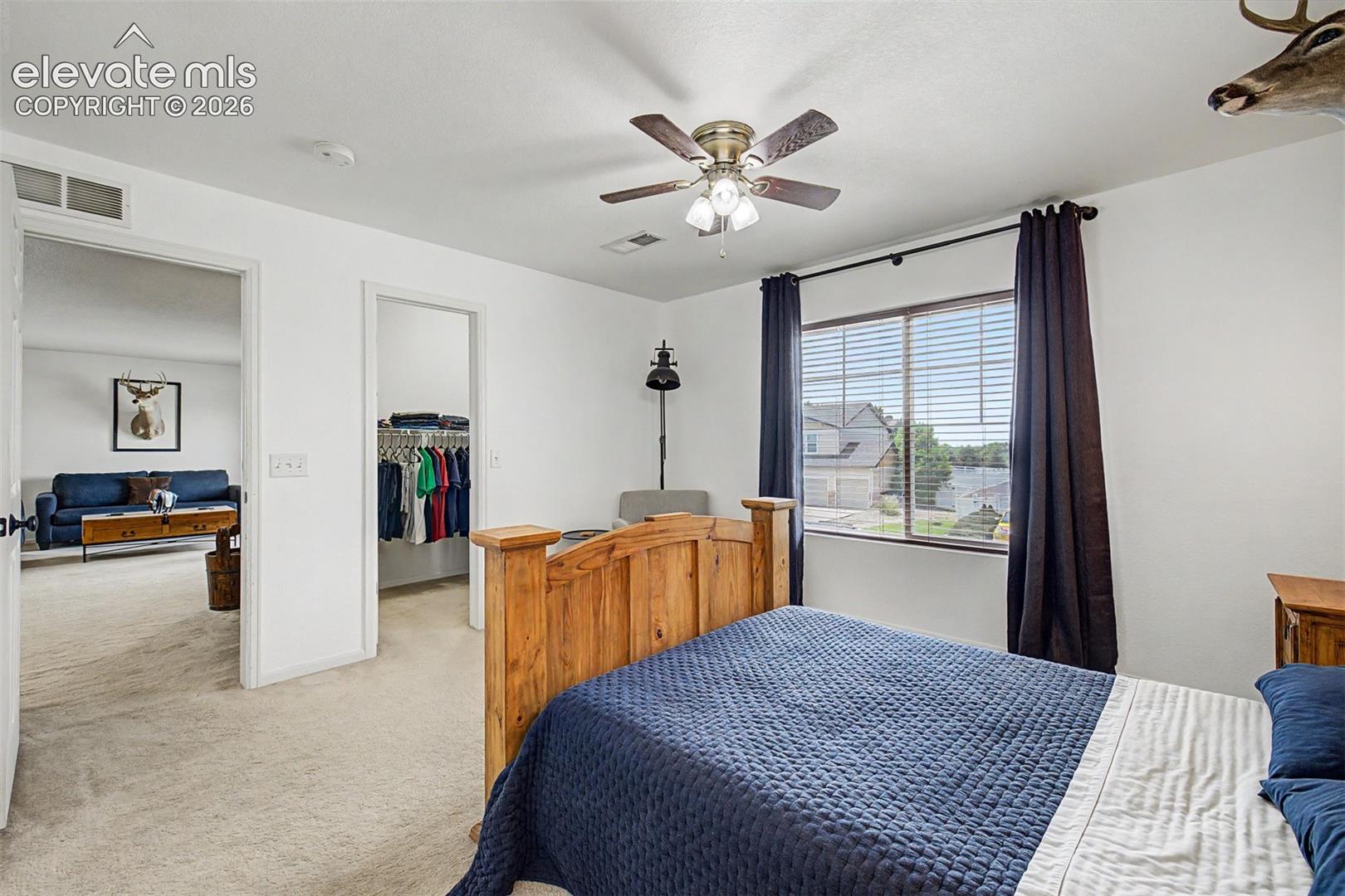 This bedroom's walk-in closet adds a highly practical and desirable feature, offering the kind of everyday storage that makes a real difference in how a home functions.