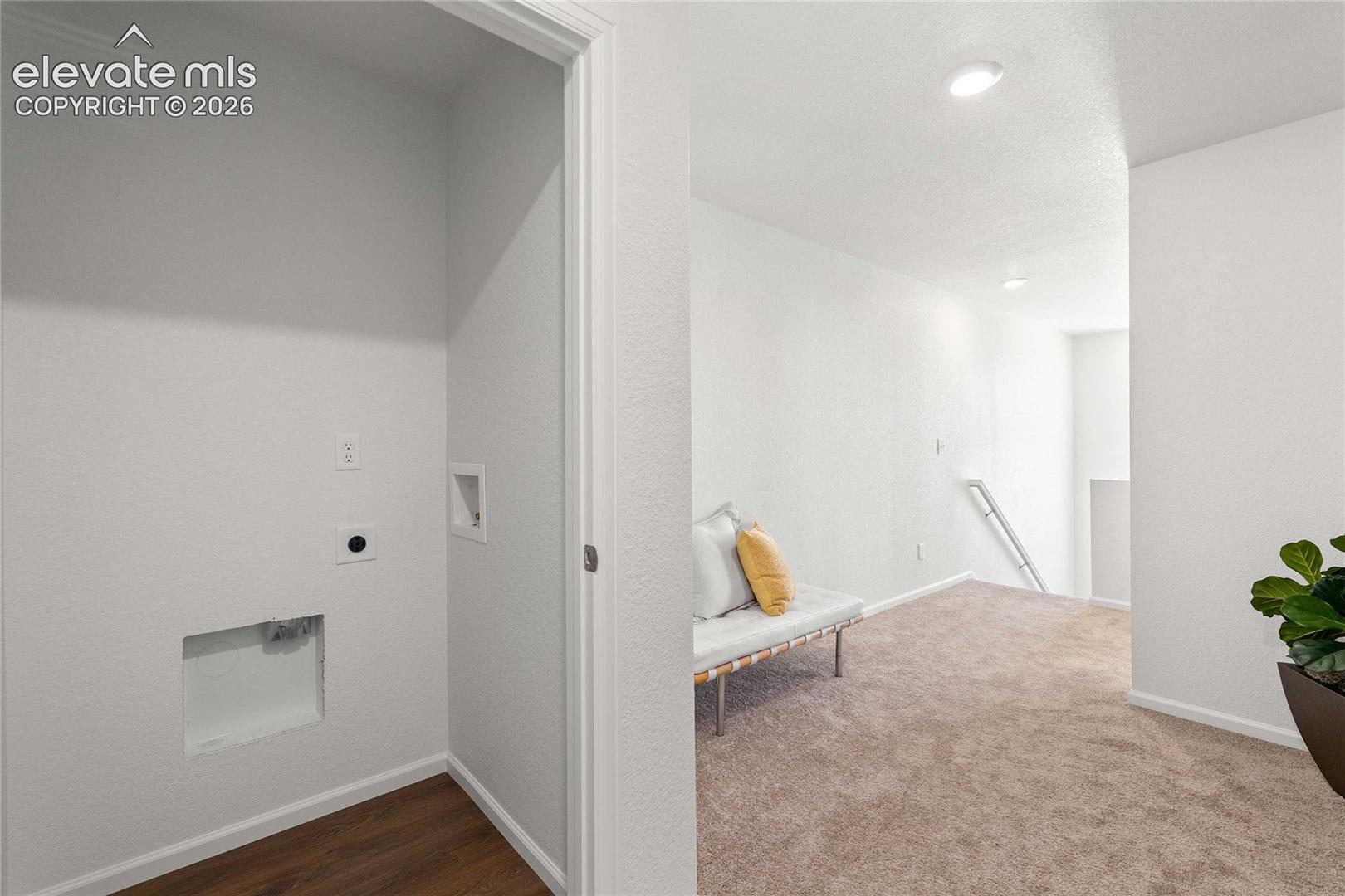 Dedicated laundry closet with wood-finish flooring
*photos  of a model home*