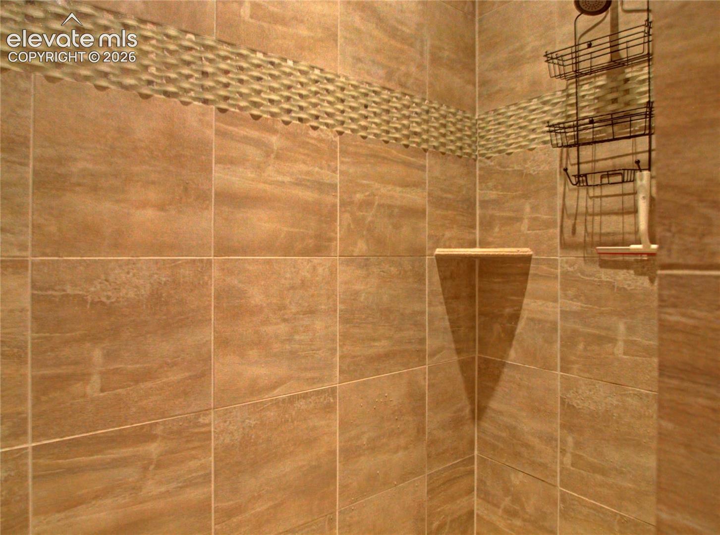 adjoining bath with walk in large shower surround.