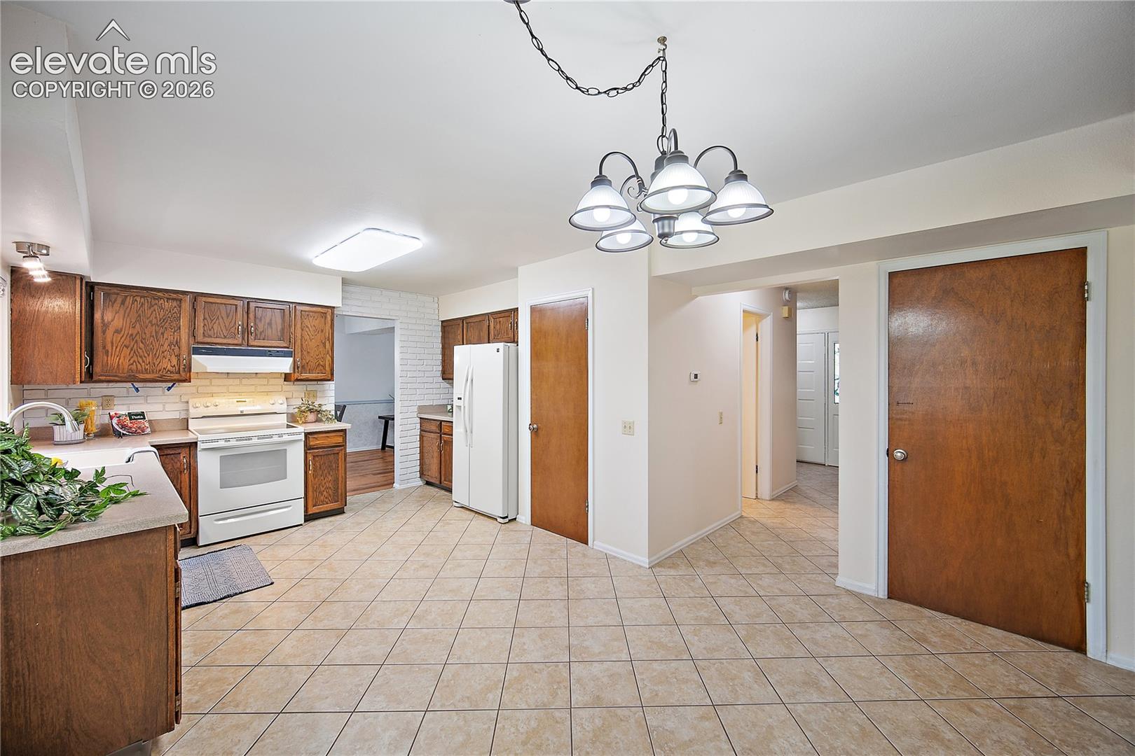Kitchen boasts plenty of cabinet and counter space with pantry.