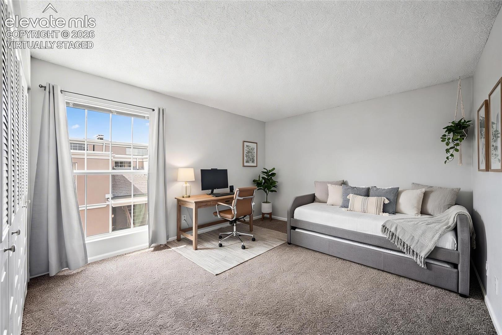 virtually staged This bedroom is being staged as an office with a daybed.  This room gives a great opportunity to use as you wish. It is right off the living room. 
