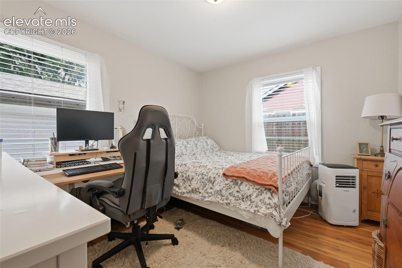 Hardwood flooring, painted walls, and window treatments