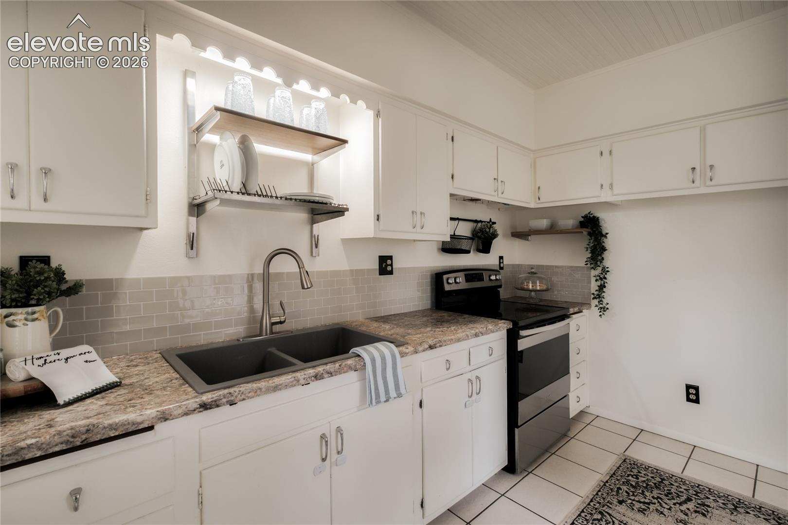 Original cabinets with trendy backsplash add to the charm!  