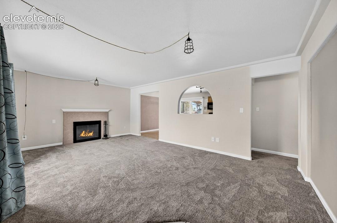 Stone-clad fireplace with mantel, recessed firebox, and a hearth
