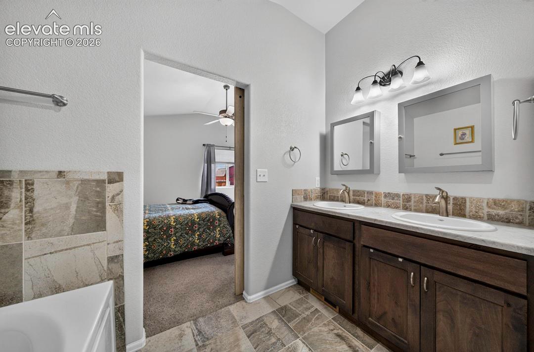 Dual vanity with integrated sinks and brushed nickel faucets set atop a dark wood-finish cabinet