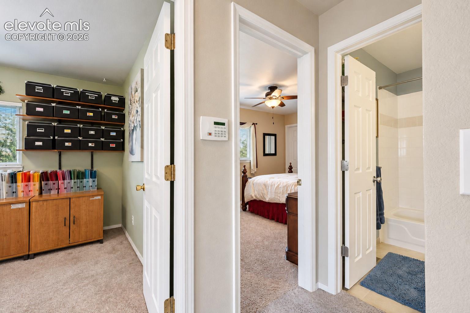 View into Bedroom's 3 and 4 with entry into a full Hall Bathroom.