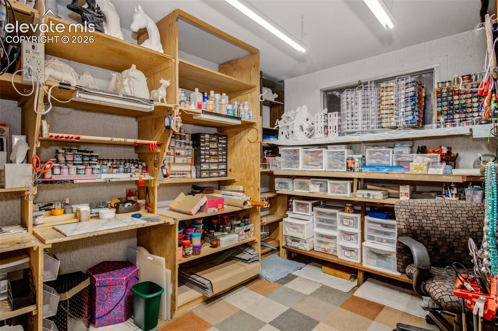 This is being used as a craft/hobby area with Shelving for all your supplies and a sit down work area