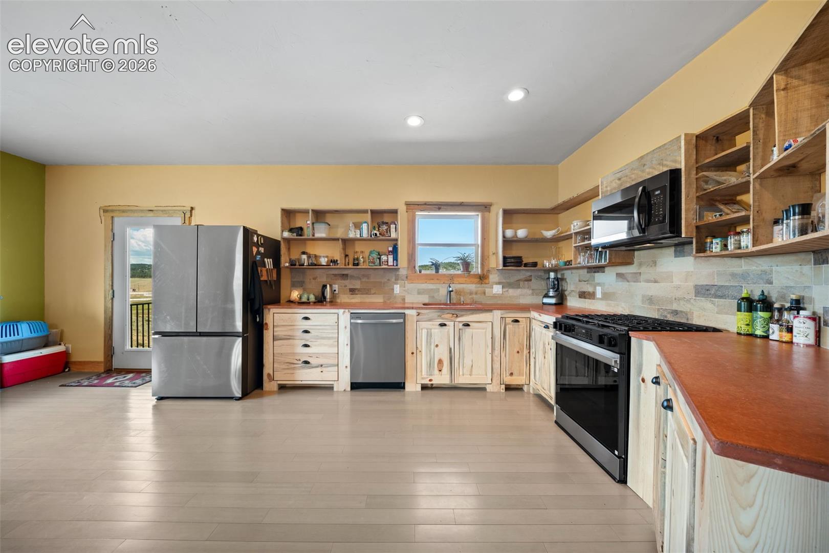 custom Bettkill pine cabinetry and fossil tile accents.